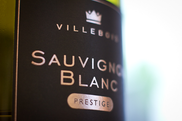 Closeup of the simple typography of this Sauvignon Blanc label — silver lettering on a black label