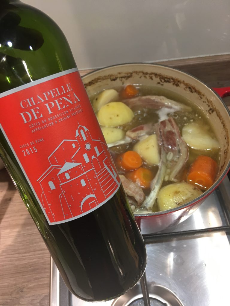 Bottle of Chapelle de Pena in front of a pot of Irish Stew