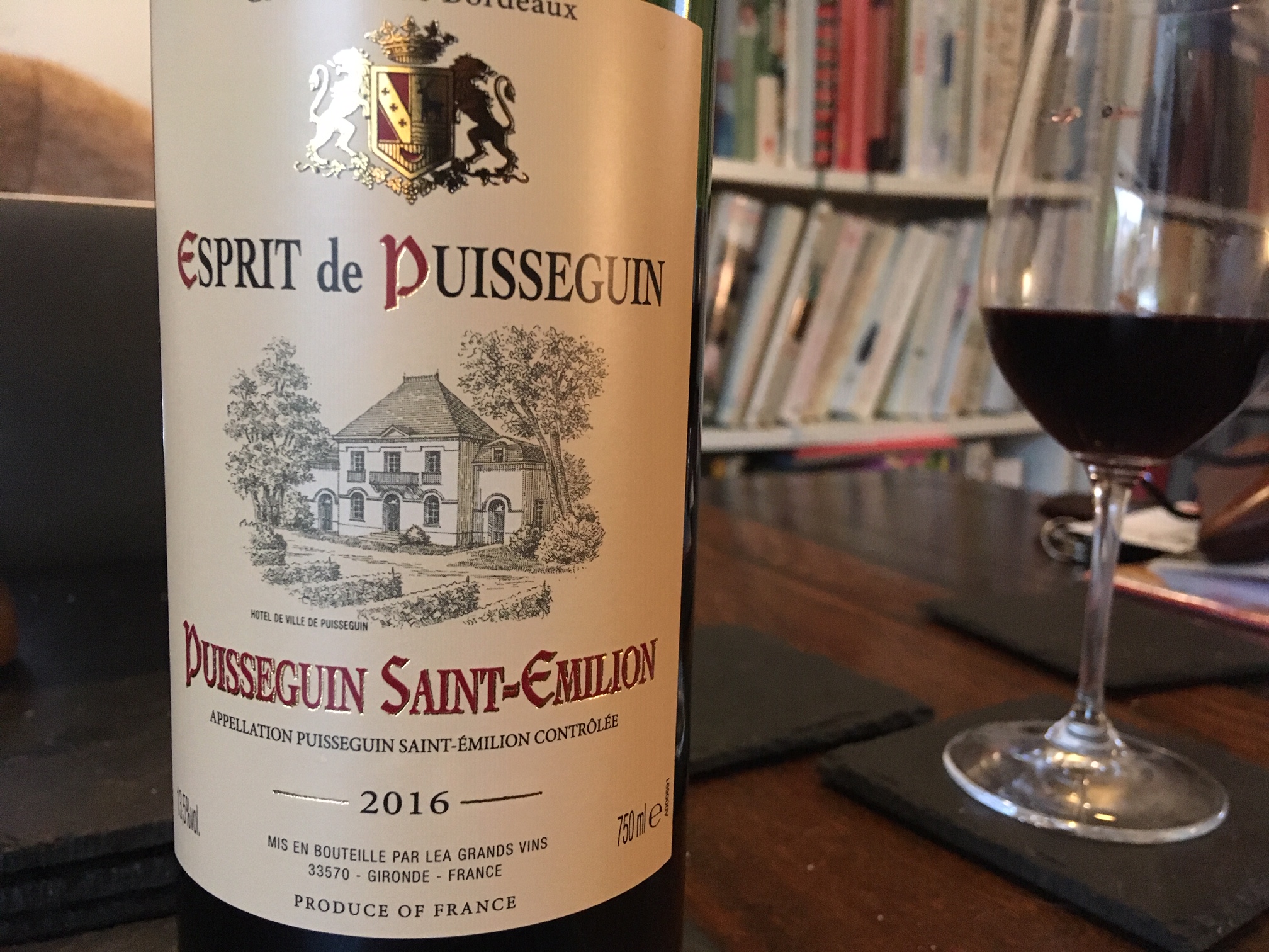 Bottle of red Bordeaux from Esprit de Puisseguin and full glass