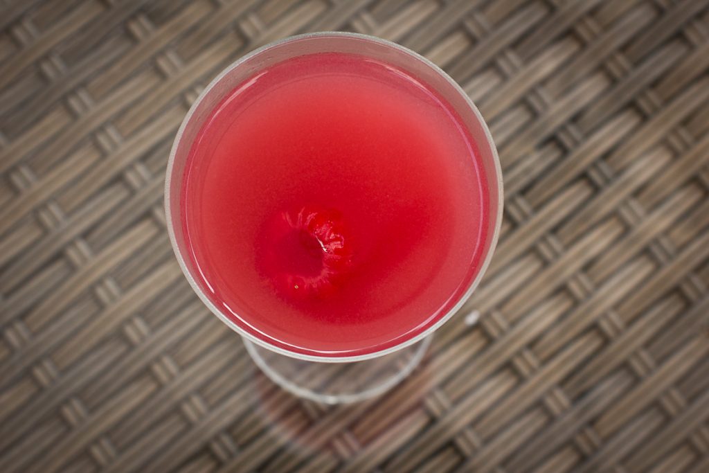 Clover Club cocktail shot from above. Raspberry red.