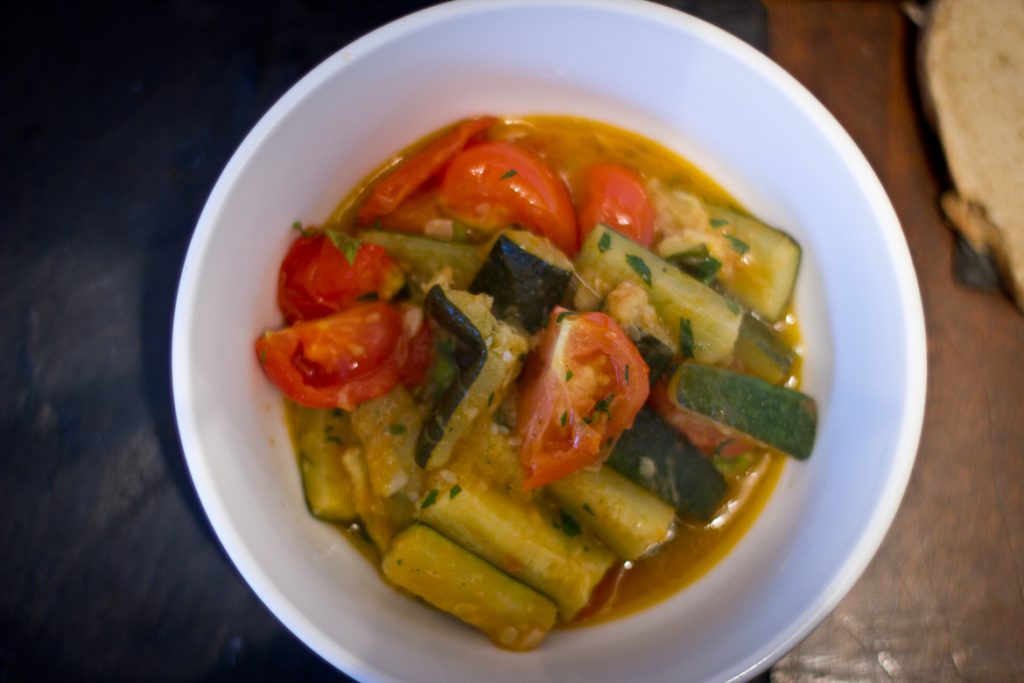 Tomato, courgette, garlic and herbs in a bowl, ready to be EATEN.